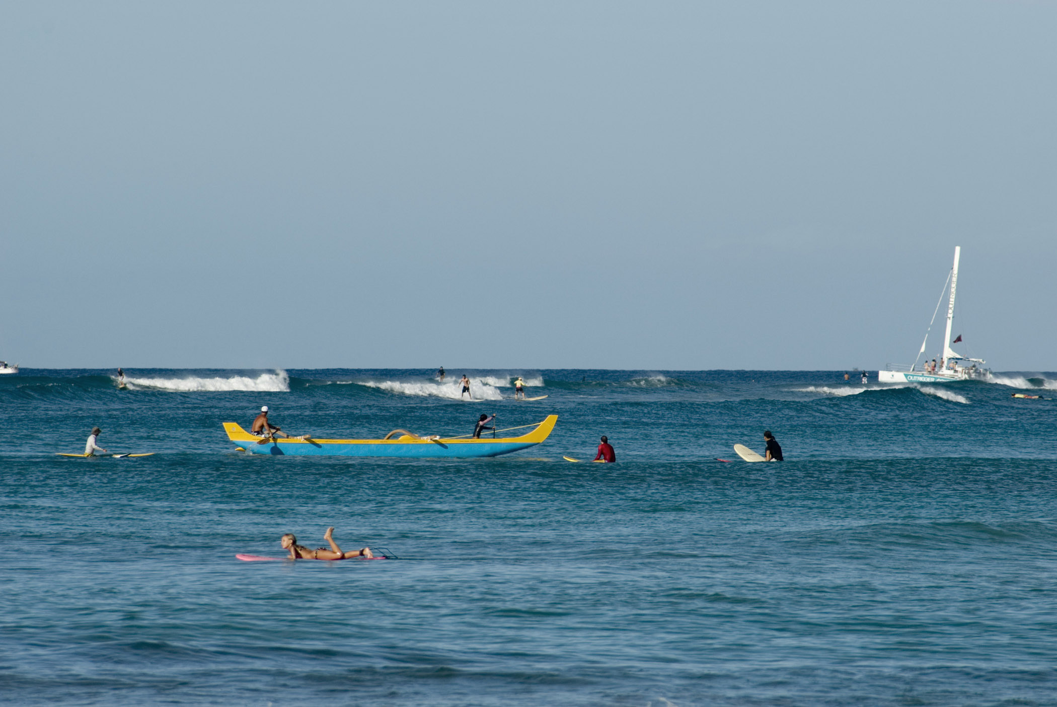 Honolulu Outrigger Canoe and Surfers in Ocean, Hawaii